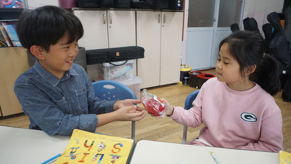 '사과데이'인 지난 24일을 맞아 원북초 학생들이 사과를 나누고 있다.